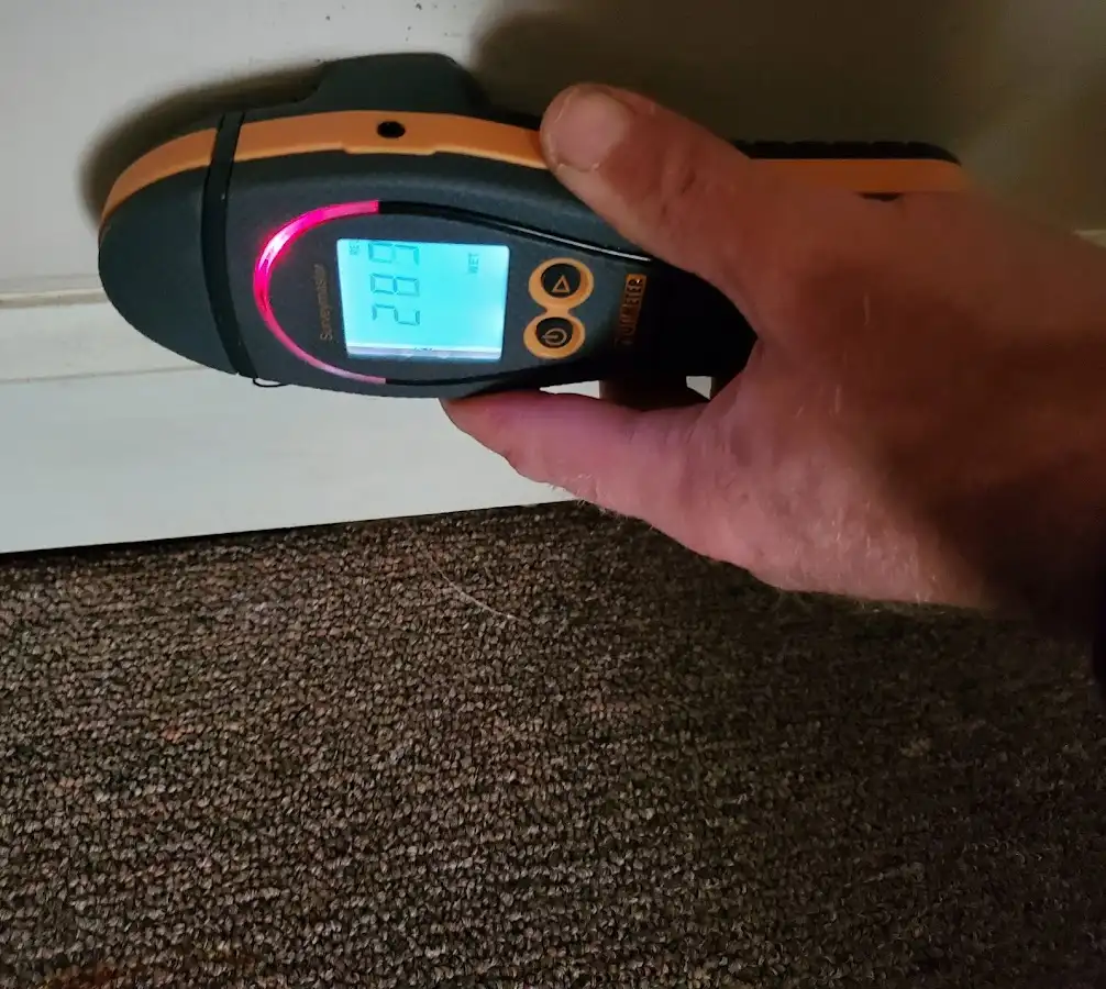 Moisture detection at baseboard during Storm Damage Restoration in Berlin